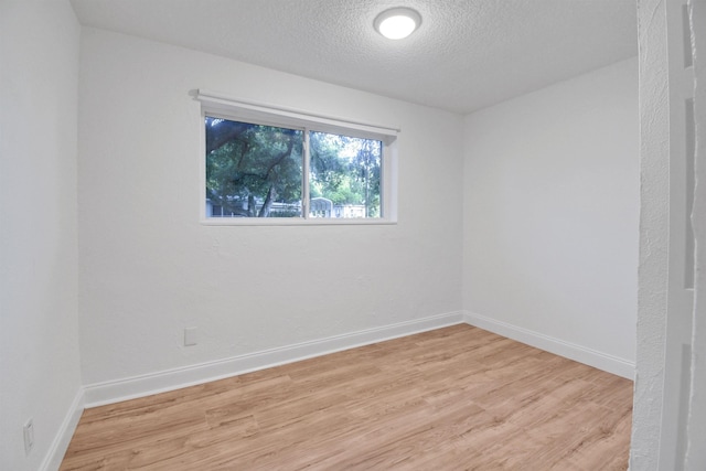 235 N Whitney St, Saint Augustine, FL 32084 - empty room featuring light wood-style flooring and a textured ceiling