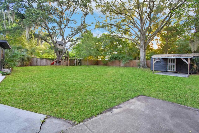 235 N Whitney St, Saint Augustine, FL 32084 - fenced backyard featuring a playground and a patio