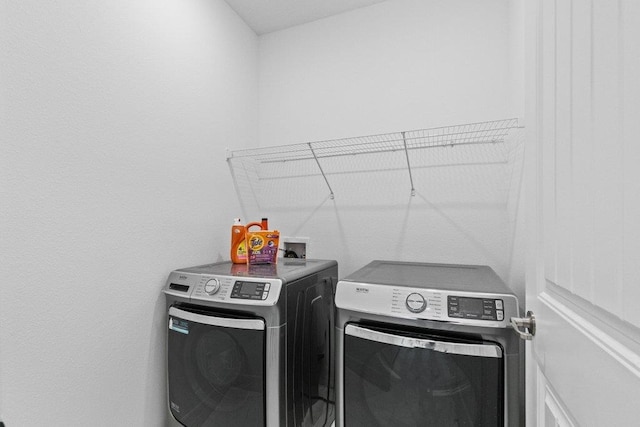 laundry room with washer and clothes dryer and laundry area