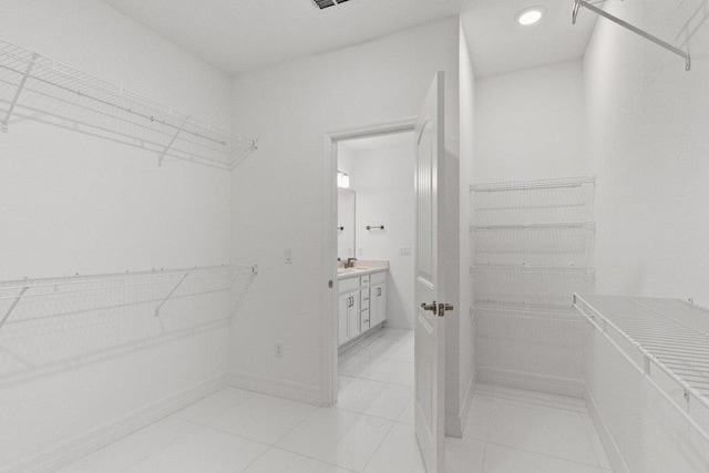 walk in closet featuring light tile patterned flooring