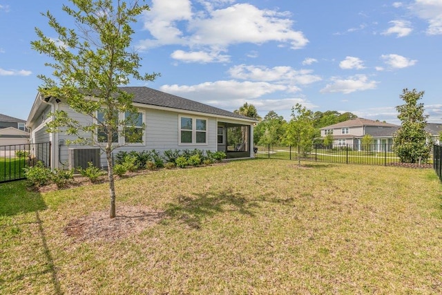 view of yard featuring a fenced backyard, a sunroom, and central air condition unit