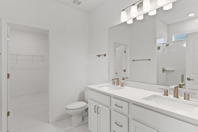 150 Shell Creek Ct, Saint Augustine, FL 32086 - bathroom featuring double vanity, a tile shower, toilet, a walk in closet, and tile patterned flooring