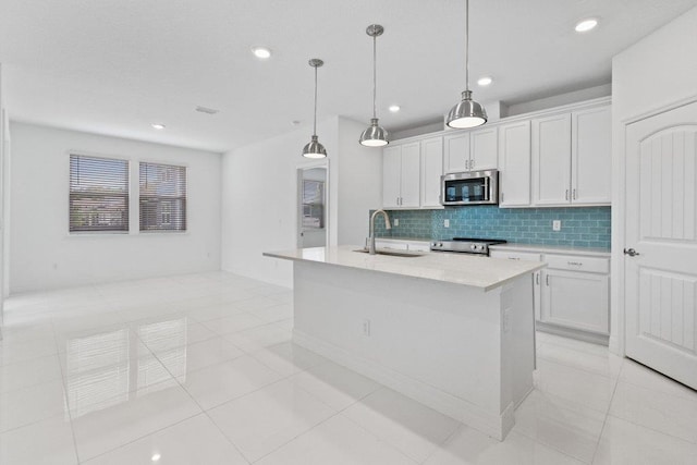 150 Shell Creek Ct, Saint Augustine, FL 32086 - kitchen with stainless steel appliances, a sink, light countertops, tasteful backsplash, and white cabinets