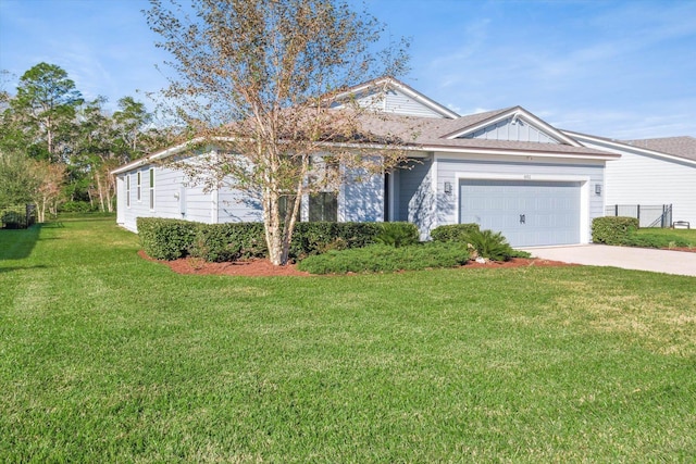 view of front of property with a garage and a front lawn