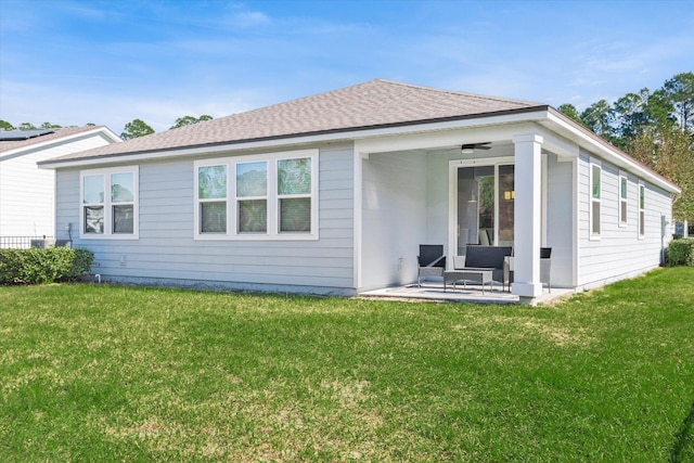 back of house featuring a lawn, a patio area, and ceiling fan