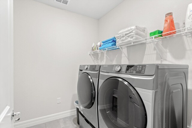 laundry area with washing machine and dryer