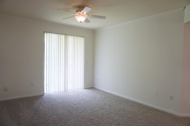 carpeted empty room featuring ceiling fan