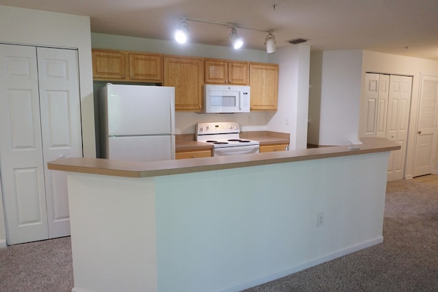 kitchen featuring a center island, white appliances, light carpet, and light brown cabinetry