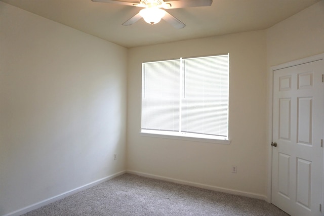 spare room with carpet and ceiling fan