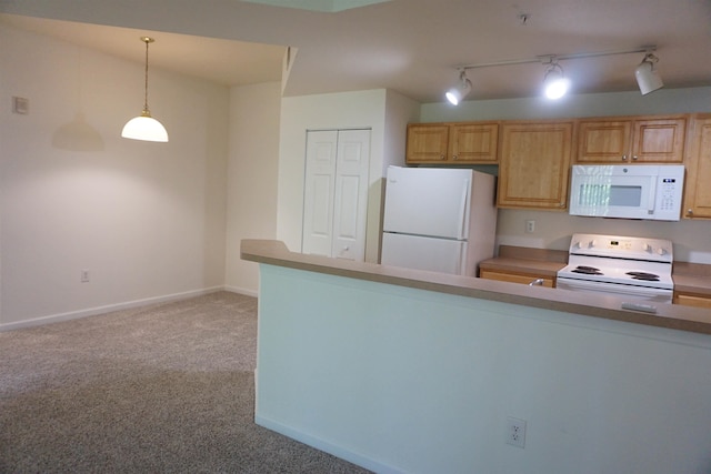 kitchen with pendant lighting, light colored carpet, white appliances, and rail lighting