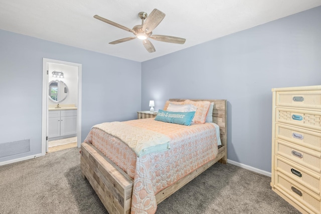 bedroom featuring ensuite bath, carpet floors, visible vents, and baseboards