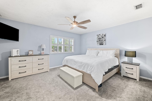 bedroom with carpet floors, visible vents, and baseboards