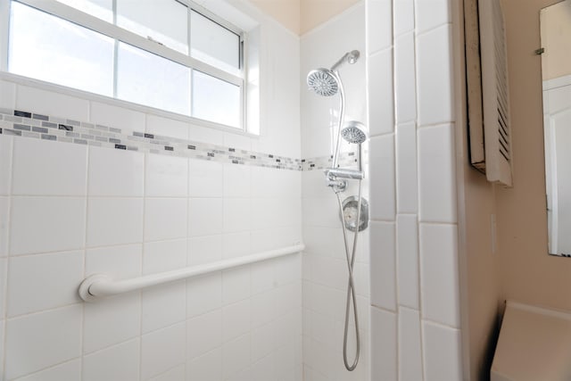 bathroom with a tile shower