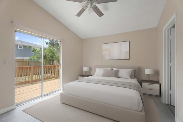 bedroom with access to exterior, wood finished floors, vaulted ceiling, and ceiling fan