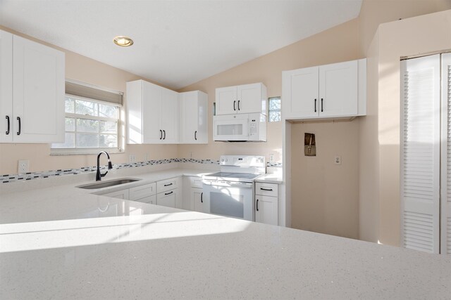 kitchen with white cabinetry, sink, white appliances, and lofted ceiling