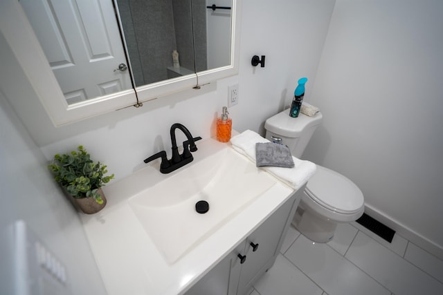 19 Phillips St, Saint Augustine, FL 32084 - half bath with tile patterned floors, toilet, vanity, and baseboards