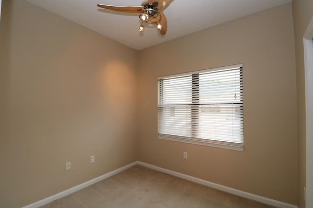 carpeted empty room featuring ceiling fan