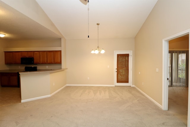 kitchen with pendant lighting, lofted ceiling, light carpet, an inviting chandelier, and kitchen peninsula