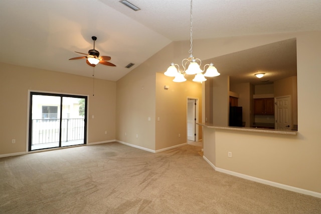 empty room featuring lofted ceiling, light colored carpet, and ceiling fan with notable chandelier