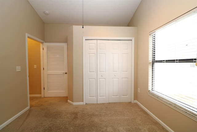 unfurnished bedroom with a closet and carpet