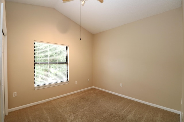 carpeted empty room featuring vaulted ceiling and ceiling fan