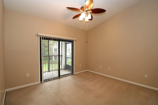 empty room featuring ceiling fan, vaulted ceiling, and carpet flooring