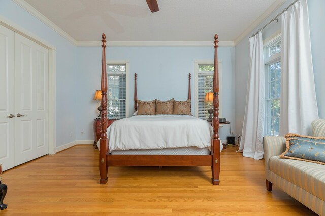 313 S Forest Dune Dr, Saint Augustine Beach, FL 32080 - bedroom with light wood-style floors, crown molding, and a ceiling fan