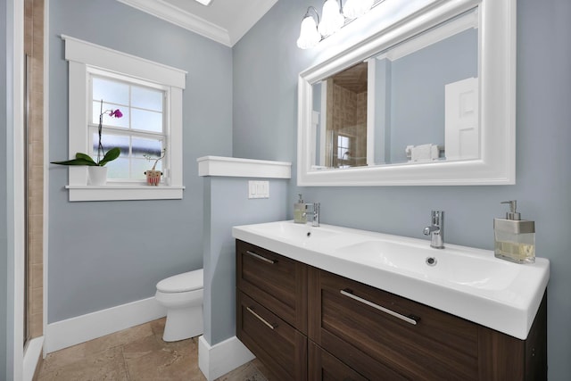 full bathroom featuring toilet, a sink, crown molding, double vanity, and baseboards