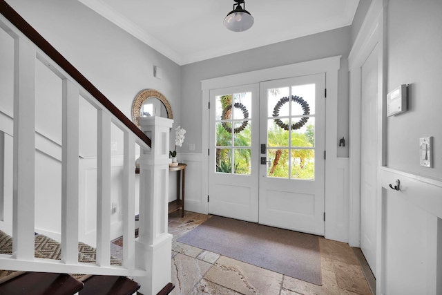 entryway featuring stone tile flooring, stairway, french doors, and ornamental molding