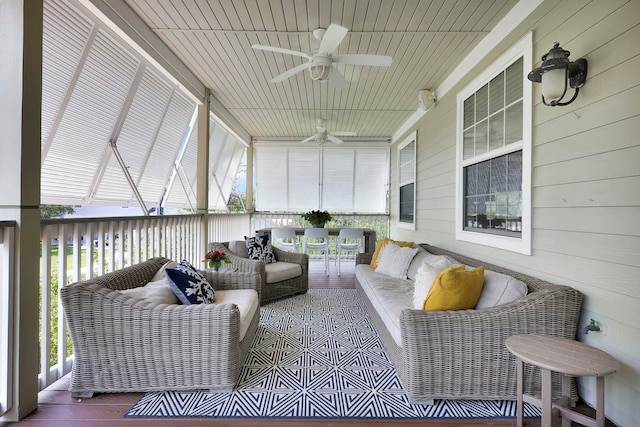 sunroom featuring a ceiling fan