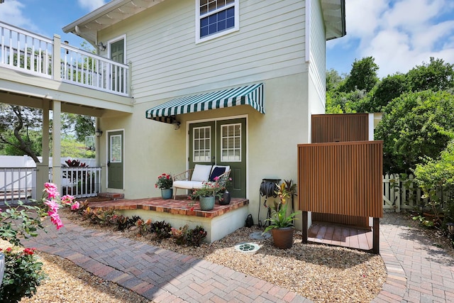 exterior space featuring stucco siding and fence