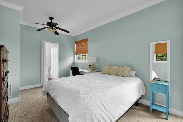 carpeted bedroom featuring ceiling fan, ensuite bath, and baseboards