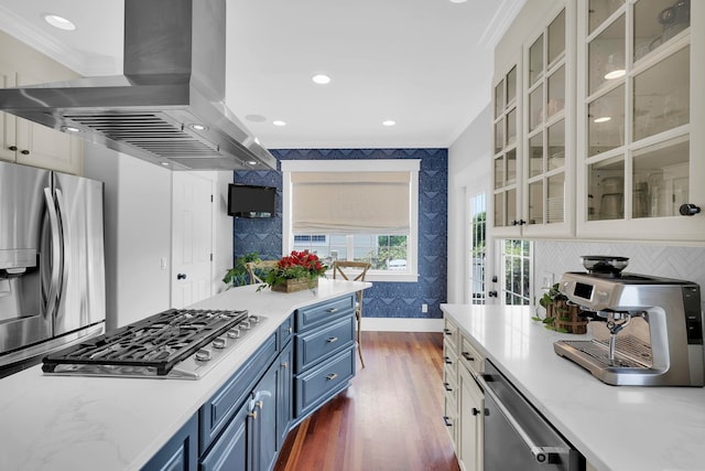 kitchen featuring wallpapered walls, dark wood finished floors, stainless steel appliances, blue cabinets, and island range hood