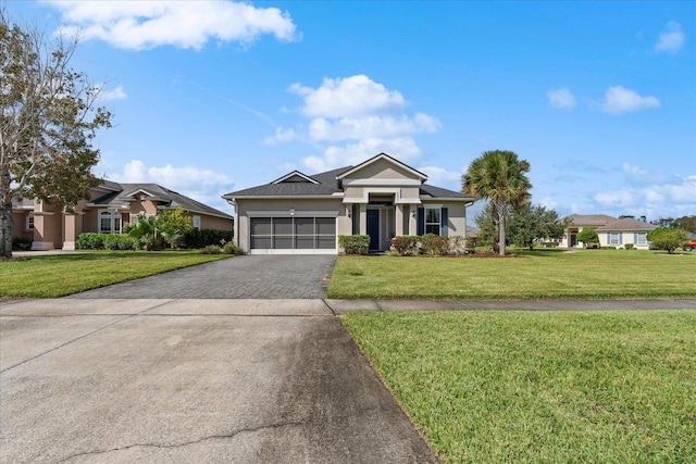 552 Christina Dr, Saint Augustine, FL 32086 - prairie-style house with stucco siding, a garage, a front yard, and decorative driveway