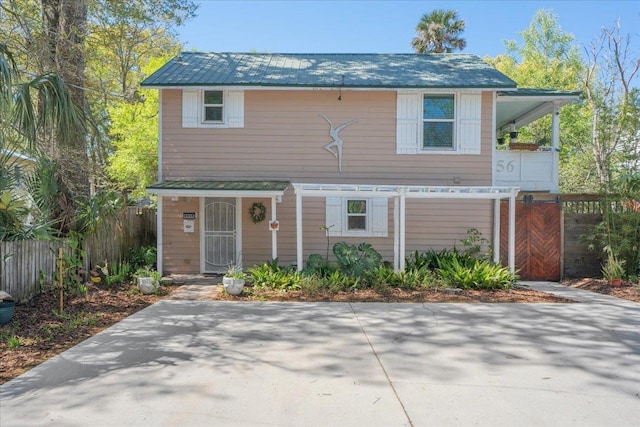 56 Dumas St, Saint Augustine, FL 32084 - view of front of house with metal roof and fence