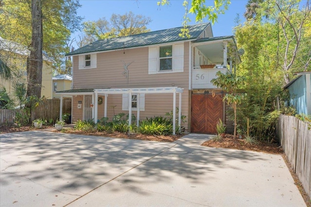 56 Dumas St, Saint Augustine, FL 32084 - view of front facade featuring fence and metal roof