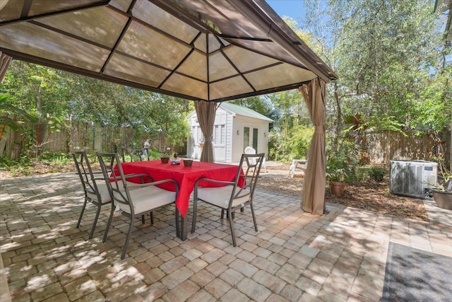 56 Dumas St, Saint Augustine, FL 32084 - view of patio with a gazebo, an outdoor structure, fence, a storage shed, and outdoor dining space