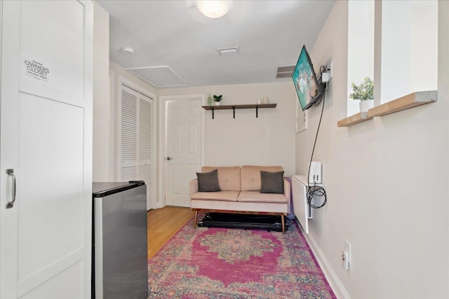 56 Dumas St, Saint Augustine, FL 32084 - living area featuring light wood finished floors and attic access