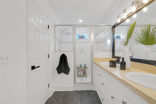 bathroom with a shower with door and vanity