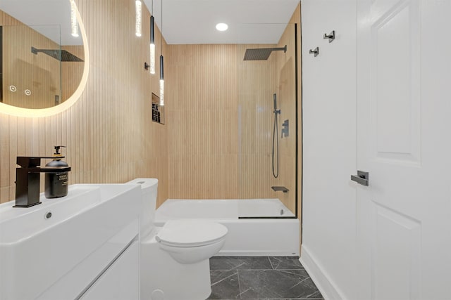 full bathroom with vanity, bathtub / shower combination, toilet, and wood walls