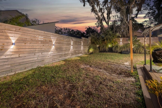 view of yard at dusk