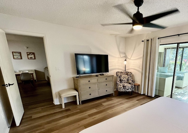 bedroom with hardwood / wood-style floors, access to outside, a textured ceiling, and ceiling fan