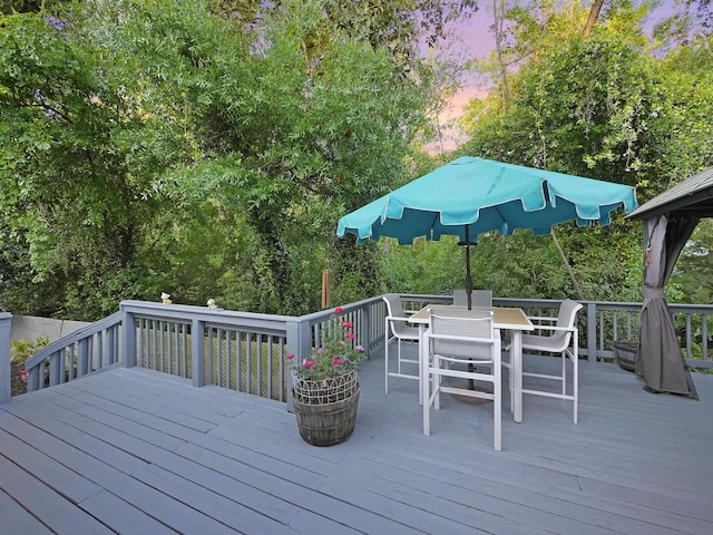wooden terrace with outdoor dining area