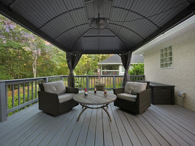 deck featuring an outdoor living space and a gazebo