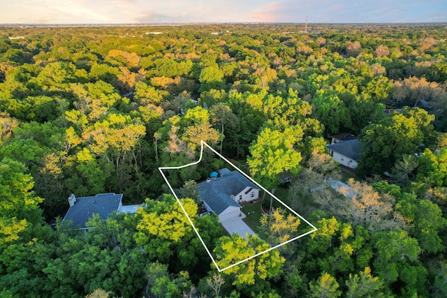 birds eye view of property featuring a view of trees