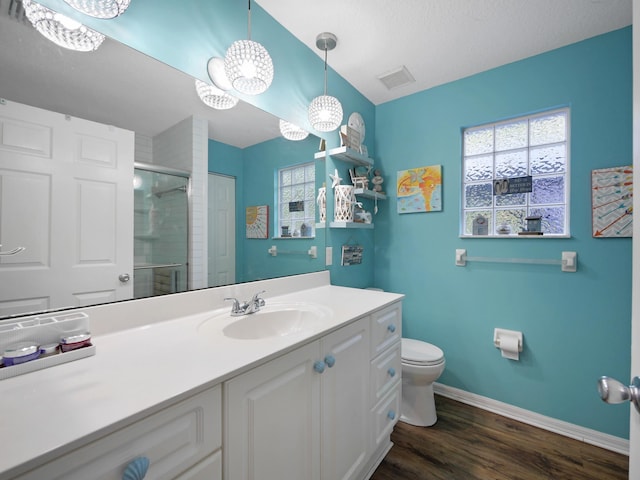 full bathroom featuring toilet, wood finished floors, visible vents, and plenty of natural light
