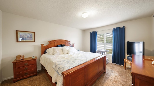 bedroom featuring a textured ceiling, carpet floors, and baseboards