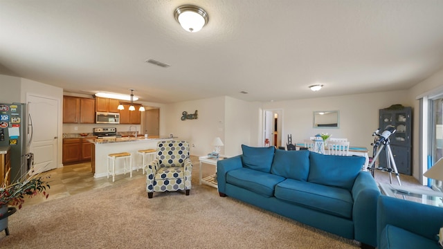 living area with light colored carpet and visible vents