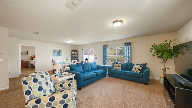 living room featuring light carpet, a textured ceiling, and visible vents