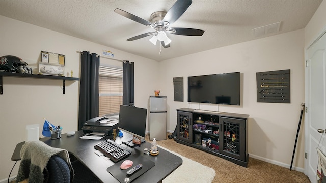 home office featuring visible vents, carpet flooring, ceiling fan, a textured ceiling, and baseboards